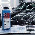 A TED Professional rapid car interior dehumidifier next to a black car in a detailing studio to speed up the drying of the clear coat