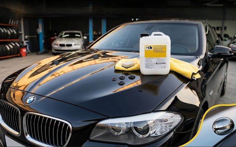 A can of TED Professional polymer car wax on the shiny hood of a black car at a detailing studio, demonstrating how to apply Liquid Wax for a mirror-like finish.